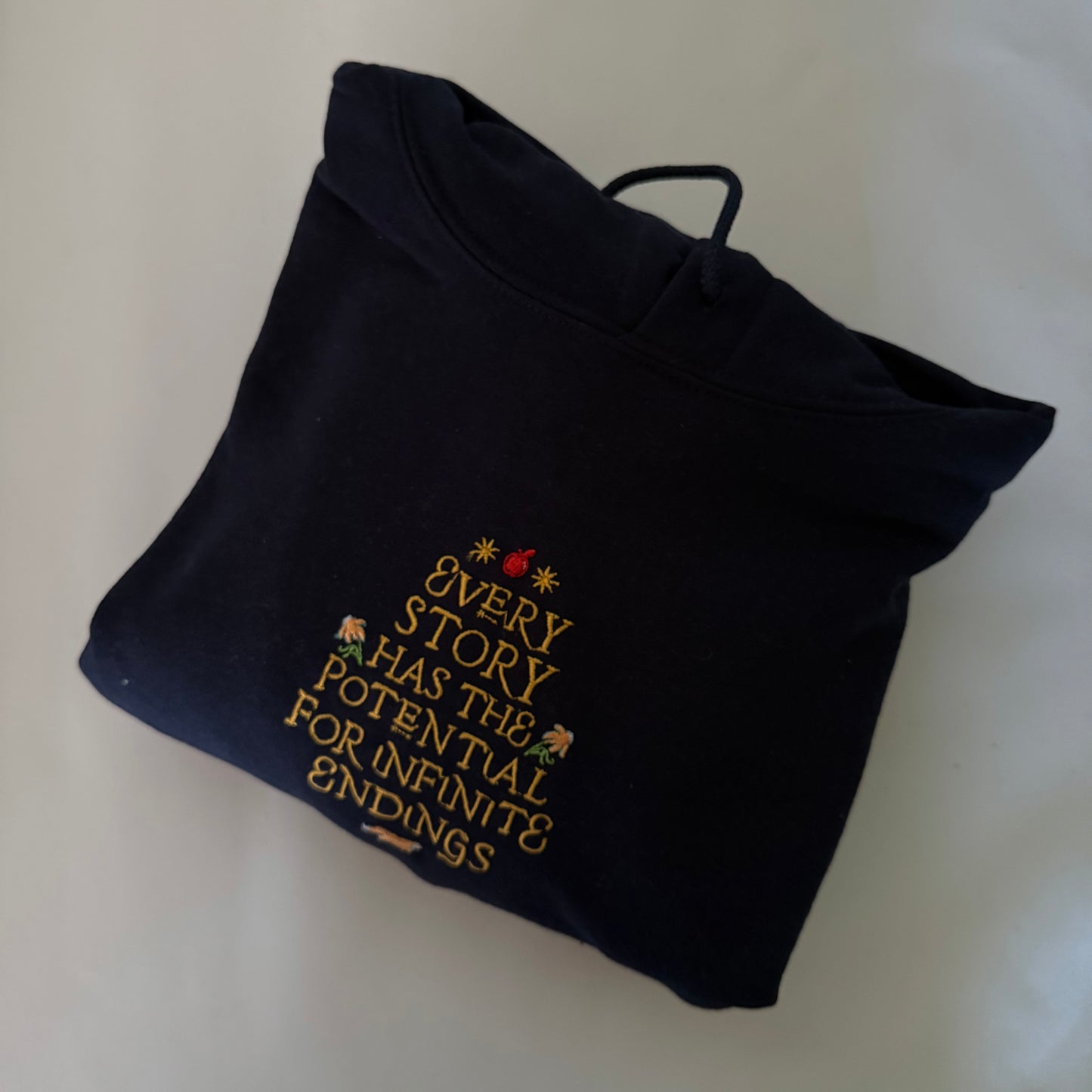 Every Story Has The Potential Navy Small Hoodie - Blue thread showing underneath Orange Flowers